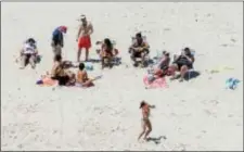  ?? ANDREW MILLS — NJ ADVANCE MEDIA VIA AP ?? In this Sunday photo, New Jersey Gov. Chris Christie, right, uses the beach with his family and friends at the governor’s summer house at Island Beach State Park in New Jersey. Christie is defending his use of the beach, closed to the public during New...