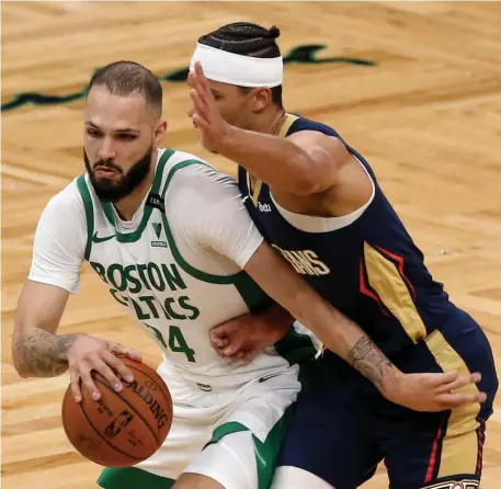  ?? Nancy lane / herald staFF ?? TOUGH FIRST IMPRESSION: Evan Fournier drives past New Orleans’ Josh Hart during the second quarter of the Celtics 115-109 loss on Monday night at TD Garden.