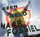  ?? PETER DEJONG/AP ?? A protester’s banner reads “No Money to Fossil” on Saturday in The Hague, Netherland­s, which also saw a separate rally against plans to curb nitrate pollution.