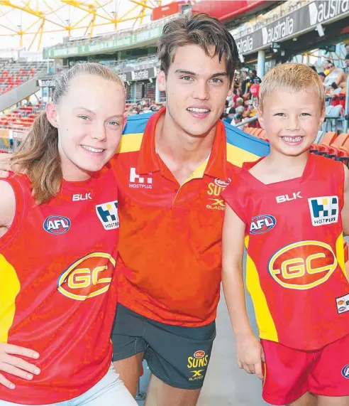  ??  ?? RISING STAR: Gold Coast Suns recruit Jack Bowes with fans Analise Churchill, 14, and Jett Churchill, 6. Picture: RICHARD GOSLING