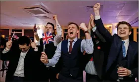  ?? AFP ?? Leave.EU supporters wave UK flags and cheer as the results come in at the Leave.EU referendum party at Millbank Tower in central London early on Friday morning.