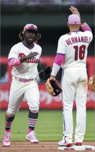  ?? DERIK HAMILTON — THE ASSOCIATED PRESS ?? Phillies outfielder Odubel Herrera, left, celebrates a victory over the New York Mets with Cesar Hernandez Sunday.