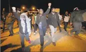  ?? Gerald Herbert Associated Press ?? PEOPLE MARCH on a bridge Friday in Memphis after video of the police beating was released.