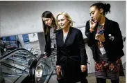  ?? PETE MAROVICH / NEW YORK TIMES ?? Sen. Kirsten Gillibrand (D-N.Y.), center with staffers, said President Donald Trump’s comments in response to her were “a sexist smear.”