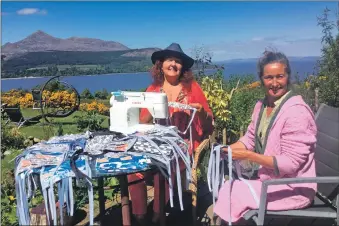  ??  ?? Carolyn McDonald and her daughter Kerry-Jane Darling Hunter working on Facemasks for Arran in their garden.