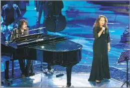  ?? Antonio Calanni Associated Press ?? A FUSION OF DIFFERENT GENRES
Gal Costa, right, performs with Sergio Cammariere at Italy’s Sanremo Music Festival in 2008. She recorded more than 35 albums in her six-decade career.