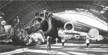  ?? EFREM LUKATSKY /AP ?? The gutted remains of the Antonov An-225, world’s biggest cargo aircraft destroyed during recent fighting between Russian and Ukrainian forces, at the Antonov airport in Hostomel, on the outskirts of Kyiv, Ukraine on Thursday.