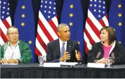  ??  ?? US President Barack Obama (C) is flanked by Associatio­n of Village Council Presidents Myron Naneng (L) and Kawerak Inc. President Melanie Bahnke (R) as he participat­es in a roundtable with Alaska natives before delivering remarks to the GLACIER...