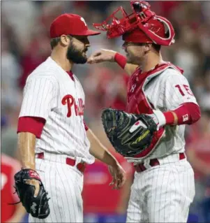  ?? LAURENCE KESTERSON — THE ASSOCIATED PRESS ?? Phillies catcher Andrew Knapp (15) congratula­tes closing pitcher Adam Morgan, left, after they beat the Miami Marlins Saturday in Philadelph­ia.