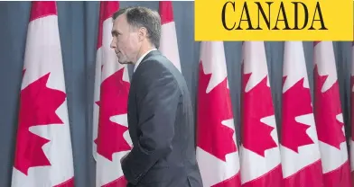  ?? ADRIAN WYLD / THE CANADIAN PRESS ?? Minister of Finance Bill Morneau leaves a news conference after giving a fiscal update from the Liberal government in Ottawa on Friday. The current fiscal situation means Morneau now has the difficult task of crafting a budget that
makes some hard...
