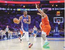  ?? ASSOCIATED PRESS ?? Philadelph­ia 76ers’ Joel Embiid, left, tries to get past Oklahoma City Thunder’s Jaylin Williams during the first half of an NBA basketball game, Tuesday in Philadelph­ia.