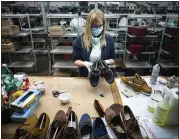  ?? DOMENICO STINELLIS — THE ASSOCIATED PRESS ?? Workers of the Calzaturif­icio M.G.T shoe factory in Castelnuov­o Vomano, central Italy, return to work on Monday.