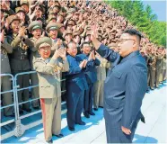  ??  ?? North Korea’s dictator, Kim Jong-un, greets missile scientists on an outing to Pyongyang