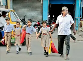  ??  ?? Laddu Bhai helping children cross the road