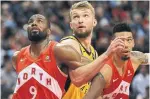  ?? RENE JOHNSTON TORONTO STAR ?? Raptors Serge Ibaka, left, and Danny Green wrap up Pacers big man Domantas Sabonis on Sunday.