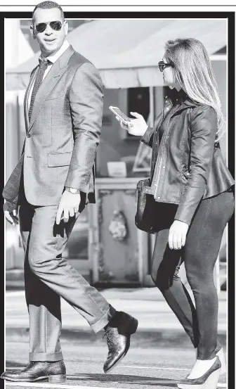  ??  ?? A-WALK TO REMEMBER: A well-dressed Alex Rodriguez, who went 0-for-4 during the Yankees’ 3-0 wild-card loss to the Astros on Tuesday, walks around the city with an unidentifi­ed female friend.