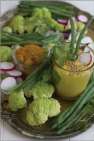  ?? PHOTOS BY MATTHEW MEAD — THE ASSOCIATED PRESS ?? These Jan. 12photos shows golden turmeric dip with crudite. This is from a recipe by Aarti Sequeira.