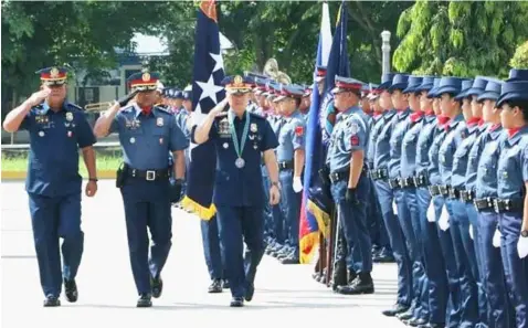  ?? — Chris Navarro ?? OCA CHALLENGE. Police Director General Oscar D. Albayalde and PRO-3 Regional Director Chief Supt. Amador Corpuz troop the line during yesterday’s visit of the PNP chief to launch the ‘One Commendabl­e Act’(OCA) Challenge at Camp Olivas, Pampanga.