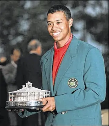  ?? BILL WAUGH / AP 1997 ?? Tiger Woods, who won the first of his 14 majors at the Masters 20 years ago, will miss the event for the third time in the past four years.