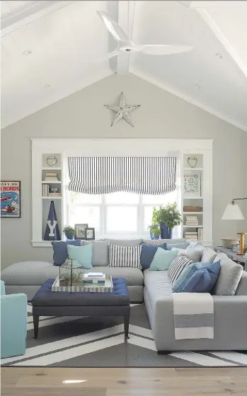  ?? TRIA GIOVAN/ COASTAL LIVING/ BURNHAM DESIGN ?? Shades of grey are used as a neutral base in this family room while bright, inviting shades of blue that evoke the ocean bring the space to life.