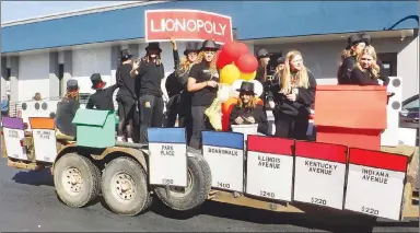  ?? Westside Eagle Observer/SUSAN HOLLAND ?? Members of the high school girls basketball team ride on their Lionopoly float in the 2022 homecoming parade. The team, with their clever twist on the classic Monopoly game, won the prize for best float entered by sports teams or school clubs.