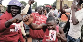  ??  ?? Supporters of Ugandan musician turned politician, Robert Kyagulanyi chant slogans outside his home after he arrived from the US in Kampala, Uganda yesterday in defiance of security measures banning rallies to welcome him home.