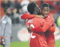  ?? NATHAN DENETTE THE CANADIAN PRESS ?? Jonathan David, right, is looking to add his offensive firepower for Canada when they play French Guiana on Sunday.