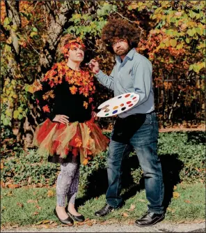  ?? (The New York Times/Evan Jenkins) ?? Shantelle and Brett Estes of Munie, Ind., won the costume contest for “Best Bob Ross Pair,” during the opening day of the “Bob Ross Experience” at the Minnetrist­a museum in Muncie.