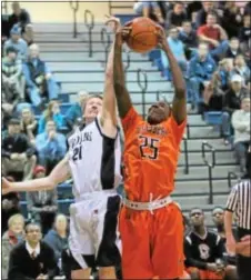  ??  ?? Chris Rowland, left, and Cameron Jones fight for the rebound.