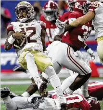  ?? JOHN BAZEMORE / AP ?? Florida State quarterbac­k Deondre Francois is tripped up by Alabama linebacker Shaun Dion Hamilton (bottom) during the first half of Saturday night’s kickoff game in Atlanta.