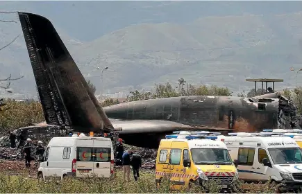  ?? PHOTO: AP ?? Firefighte­rs and security officers work at the scene of the fiery crash of an Algerian military transport plane at Boufarik. The Russian-made II-76 aircraft crashed just after takeoff, killing 257 people in the worst aviation disaster in Algeria’s...