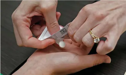  ?? ?? A doctor gives a patient the first of two pills for a medical abortion in Kansas City, Kansas, on 12 October 2022. Photograph: Charlie Riedel/ AP