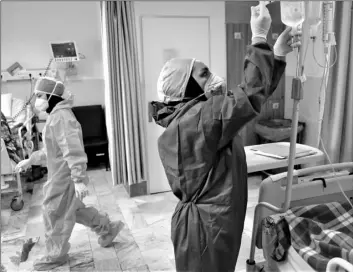  ?? AP PHOTO/VAHID SALEMI ?? In this June 16 file photo, nurses tend to COVID-19 patients at the Shohadaye Tajrish Hospital in Tehran, Iran.