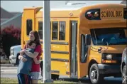  ?? KEVIN MOLONEY / GETTY IMAGES ?? A student and adult embrace outside Noblesvill­e West Middle School after a shooting at the school Friday in Noblesvill­e, Indiana. One teacher and one student were initially reported injured.