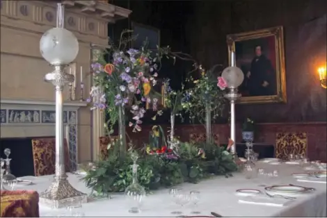  ?? DEAN FOSDICK VIA AP ?? This photo provided by Dean Fosdick taken at the Biltmore Estate near Asheville, N.C., shows a dining room table set for a dinner party. It integrates a huge floral centerpiec­e with a number of accessorie­s including glassware, tableware and antique...