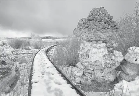  ?? Brian van der Brug Los Angeles Times ?? THE BOARDWALK at the Mono Lake Tufa State Natural Reserve splits exposed tufa towers near a spot where the lake level was in 1941.