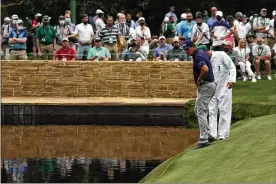  ?? GREGORY BULL / ASSOCIATED PRESS ?? Phil Mickelson looks for his ball along the water edge at the 15th hole on Thursday. Mickelson shot a 3-over 75 in the first round.