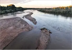  ??  ?? Sandbars caused by low water levels develop in the Rio Grande as it flows through Albuquerqu­e in Septemeber. The effects of winter weather have eased some drought concerns in the Southwest.