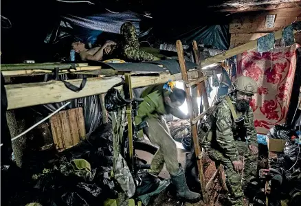  ?? AP ?? Ukrainian paratroope­rs of 80 Air Assault brigade rest inside a dugout at the front line near Bakhmut. Ukraine says the fighting for the strategic city has ‘‘escalated,’’ with Russian forces mounting a fresh offensive.