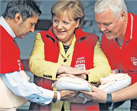  ??  ?? Chancellor Angela Merkel of Germany attends a CPR course organised by the medical university of the north-eastern town of Greifswald on the eve of the general elections