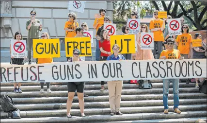  ?? Ralph Barrera Austin American-statesman ?? Protesters gather at the University of Texas campus to oppose a new state law that expands the rights of concealed handgun license holders.