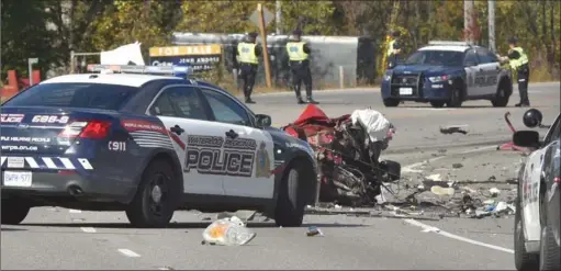  ??  ?? The remains of a vehicle that struck a transport truck head-on Thursday morning can be seen strewn across Highway 6. A man and a woman in the car were killed in the collision.