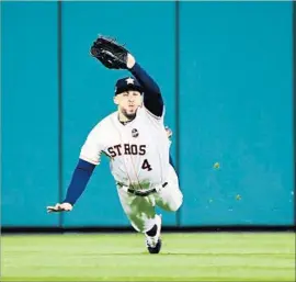  ?? Wally Skalij Los Angeles Times ?? GEORGE SPRINGER of the Astros makes a diving catch in the fifth inning Friday, preventing the Dodgers from scoring a much-needed run.