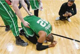  ?? LYNNE SLADKY / ASSOCIATED PRESS ?? Boston Celtics center Al Horford falls to his knees Sunday after winning Game 7 of the Eastern Conference finals against the Miami Heat.