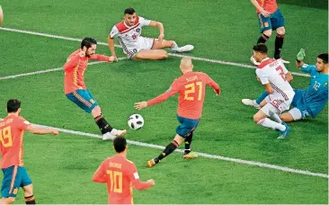  ?? AFP ?? Spanish midfielder Isco (left) scores his side’s first goal during their Group ‘B’ match against Morocco at the Kaliningra­d Stadium in Kaliningra­d on Monday night. —