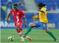  ?? Reuters ?? Canada’s Alphonso Davies (12) vies for the ball against French Guiana’s Rhudy Evens. —