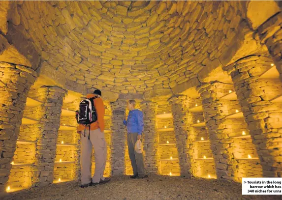  ??  ?? Tourists in the longbarrow which has 340 niches for urns