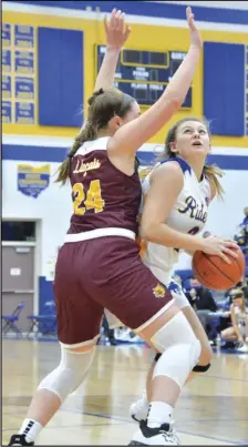  ?? Staff photo/ Jake Dowling ?? St. Marys’ Haley Felver works around Kalida’s Camille Hovest in the first half of a non-league girls basketball game on Tuesday.