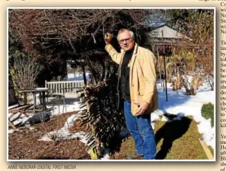  ?? ANNE NEBORAK-DIGITAL FIRST MEDIA ?? Michael Petrie shows off the bird’s nest he built for the exhibit at the Philadelph­ia Flower Show. His exhibit will feature Olympic National Park.