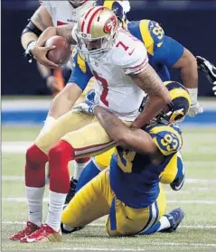  ?? Tom Gannam
Associated Press ?? COLIN KAEPERNICK (7), being tackled by St. Louis’ Ethan Westbrooks, is no longer the starting quarterbac­k for San Francisco.